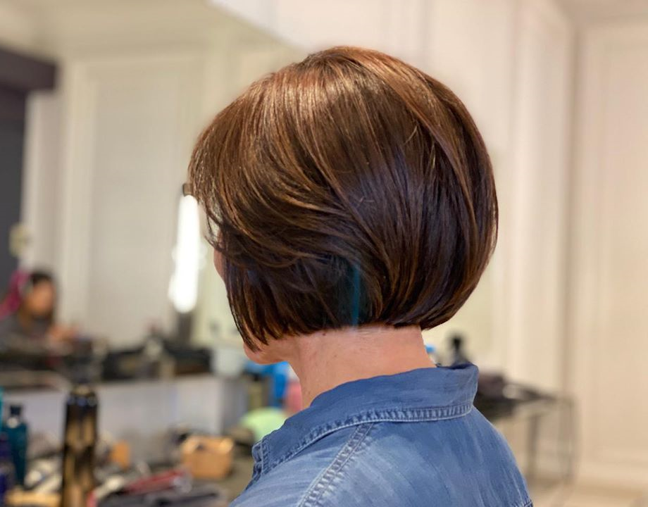 woman in jean jacket with chocolate brown colored short hair