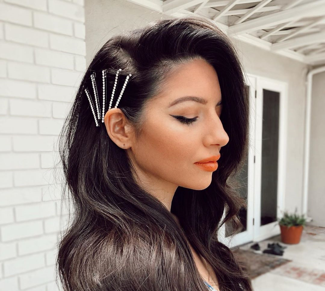 woman with long black hair and shiny metal hair clips