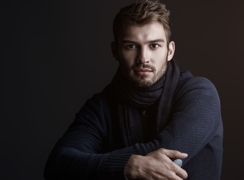 haircutman-1 mens haircut with a man sitting down with his arms crossed wearing a scarf